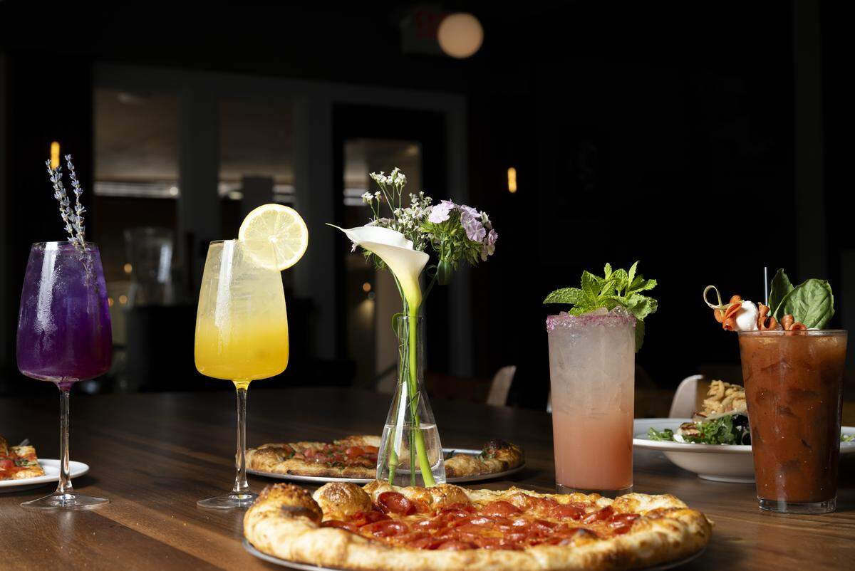 A selection of spritzes and other cocktails available at The Edit Social House line a table on Thursday, May 21, 2026, at the Oakbrook Golf Club in Lakewood, Wash.