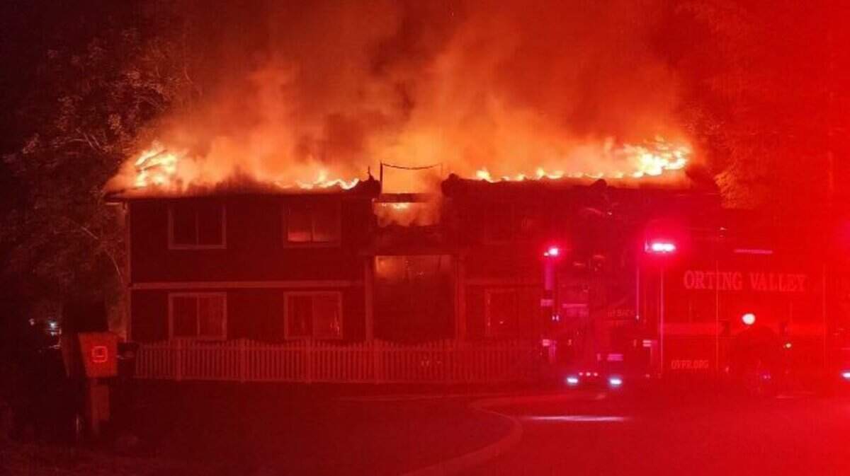 An apartment building burns early Wednesday morning in Sumner. The fire displaced four families.