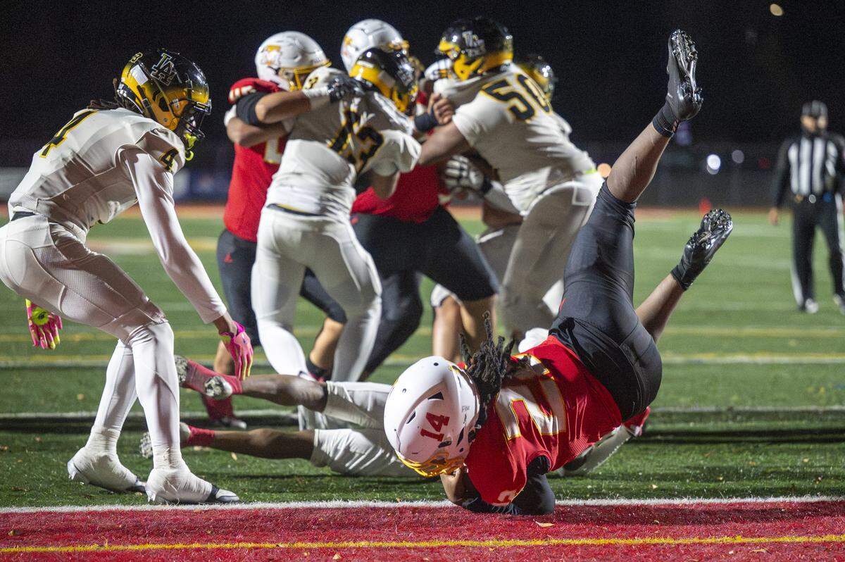 Mount Tahoma running back Keshawn Hines (22) lands in the end zone for a touchdown against Lincoln on Saturday, Nov. 22, 2025, in Tacoma, Wash.