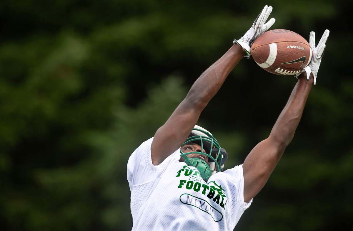 Tumwater running back Jaylin Nixon stretches out to make a catch during preseason football practice at Tumwater District Stadium in Tumwater, Washington, on Thursday, Aug. 22, 2024.