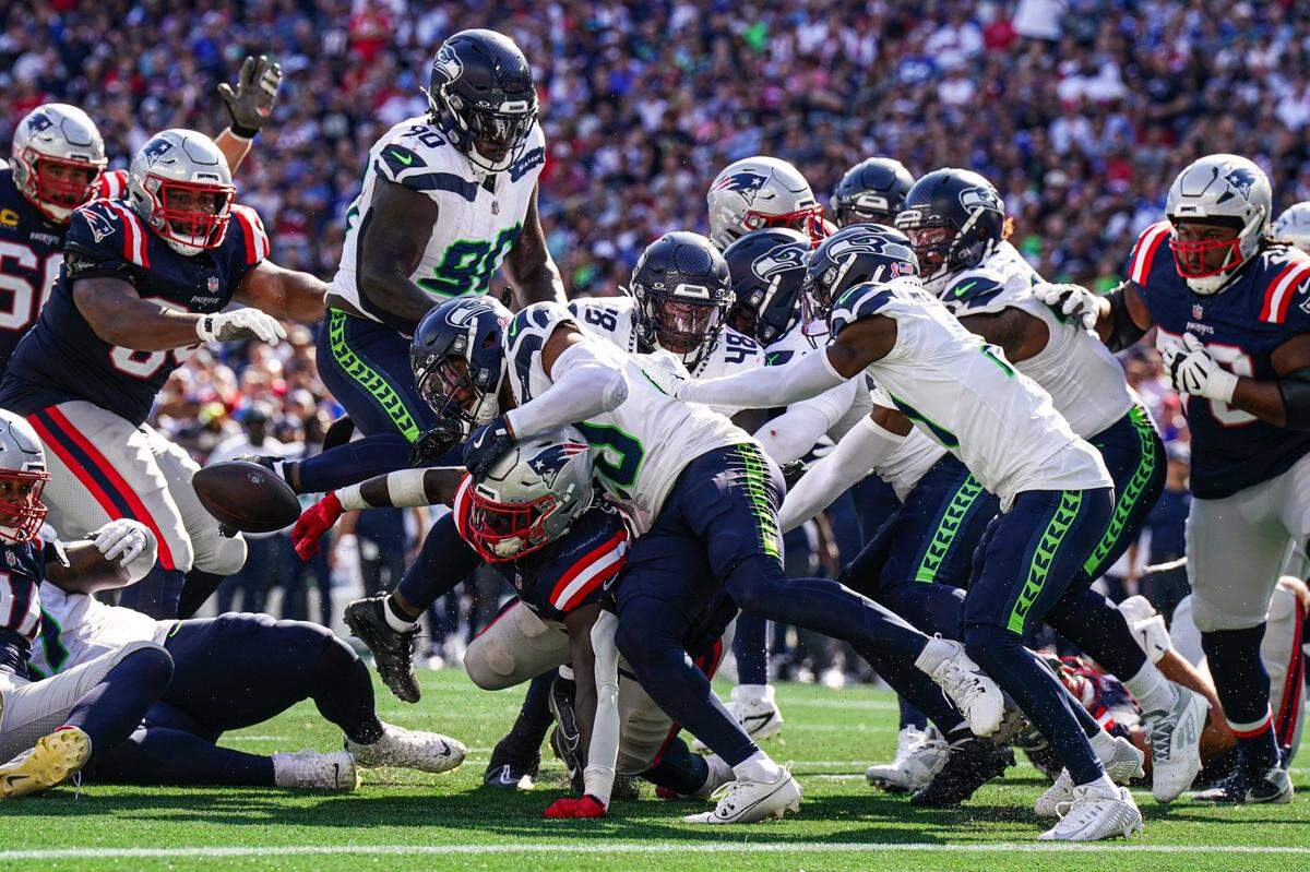 Sep 15, 2024; Foxborough, Massachusetts, USA; New England Patriots running back Rhamondre Stevenson (38) looses contriol of the ball against the Seattle Seahawks in the second half at Gillette Stadium. Mandatory Credit: David Butler II-Imagn Images