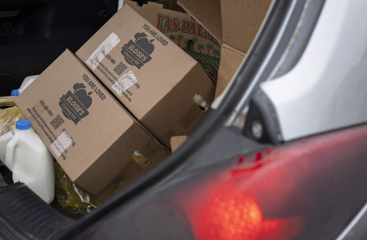 Eloise’s Cooking Pot boxes, which include pantry items for cooking, as well as fresh produce, are loaded into trunks during a drive through food distribution on Wednesday, July 8, 2026, at the Tacoma Dome in Tacoma, Wash.