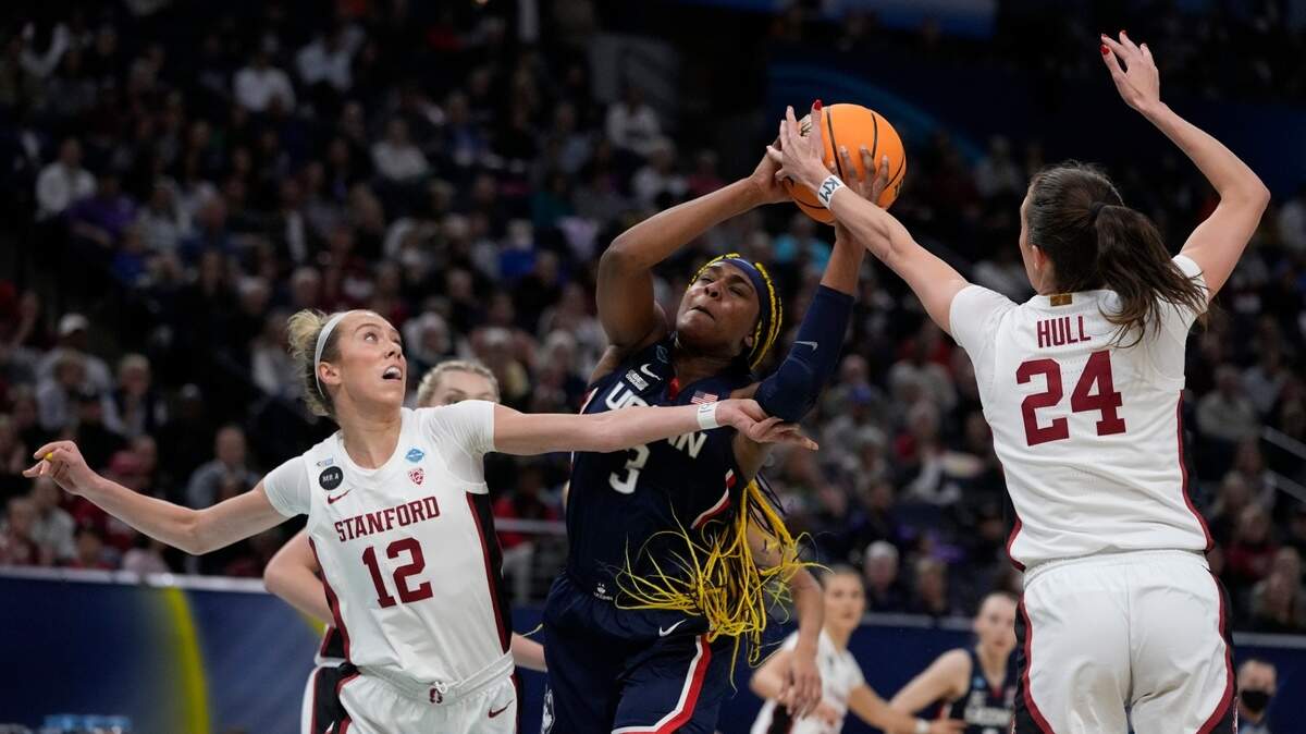 Stanford’s Lacie Hull and Lexie Hull stop UConn’s Aaliyah Edwards during the first half of a college basketball game in the semifinal round of the Women’s Final Four NCAA tournament Friday, April 1, 2022, in Minneapolis. (AP Photo/Charlie Neibergall)
