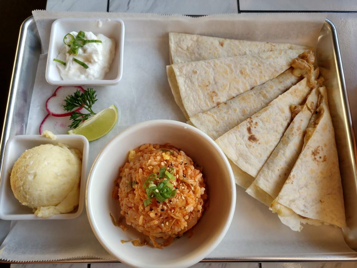 A chicken quesadilla with kimchi fried rice and potato salad from Takos Koreanos.