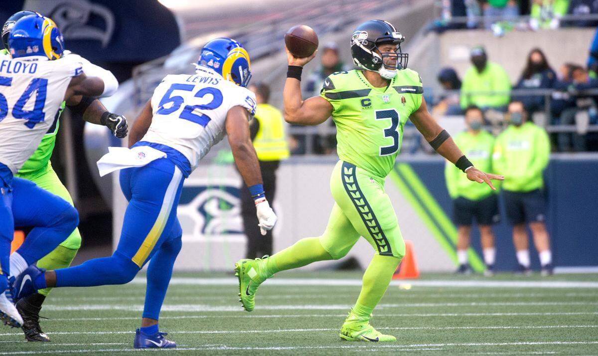 Seattle Seahawks quarterback Russell Wilson fires a pass under pressure from Los Angeles Rams outside linebacker Terrell Lewis during the NFL’s Thursday Night Football game at Lumen Field in Seattle, Washington, on Oct. 7, 2021.