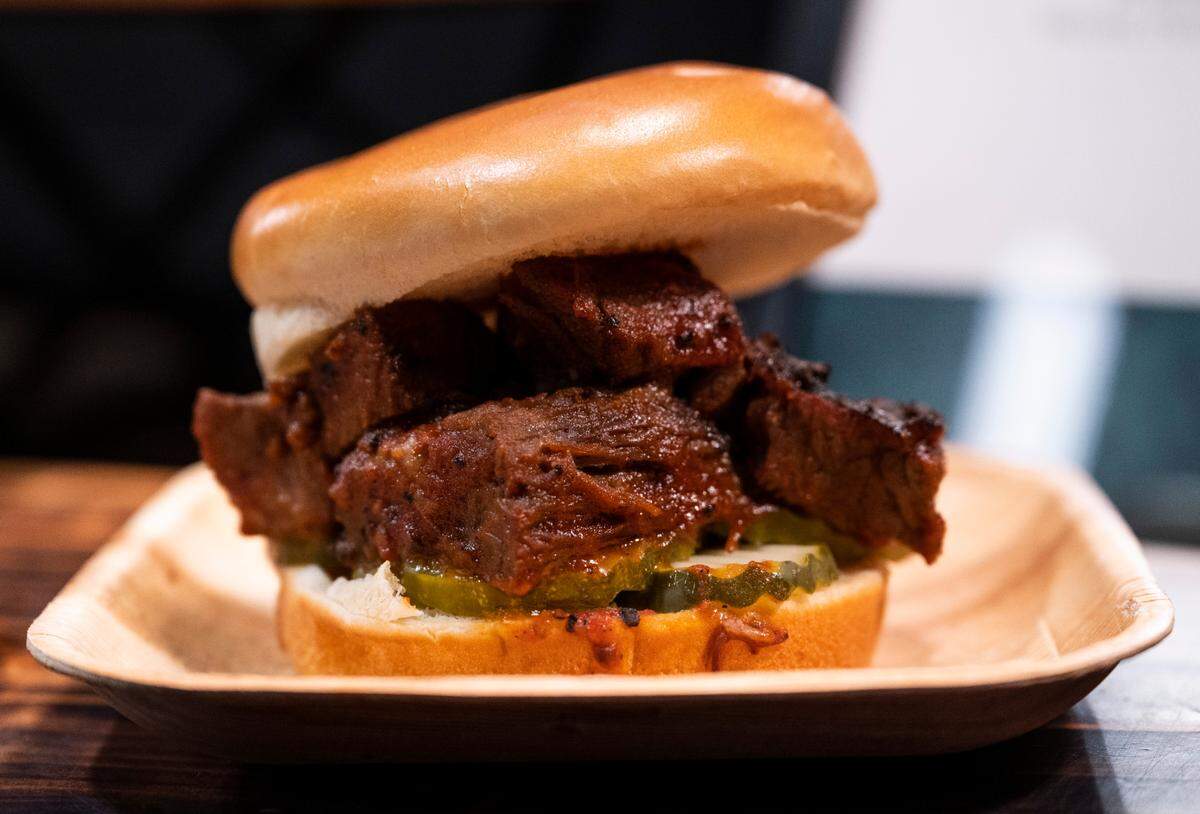 Many of the arena’s offerings feature brands based in Seattle and the greater Pacific Northwest, including Richard’s Too Good BBQ on this house-smoked brisket sandwich.