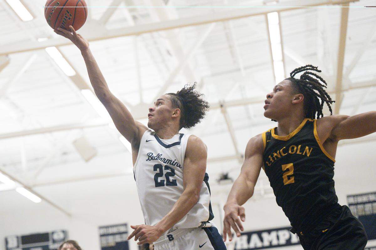 Bellarmine Lions junior Ronnie Wiggins (22) attempts a two-point shot with pressure from Lincoln Abes senior Kasey Williams (2) on Wednesday, Jan. 28, 2026, in Tacoma.