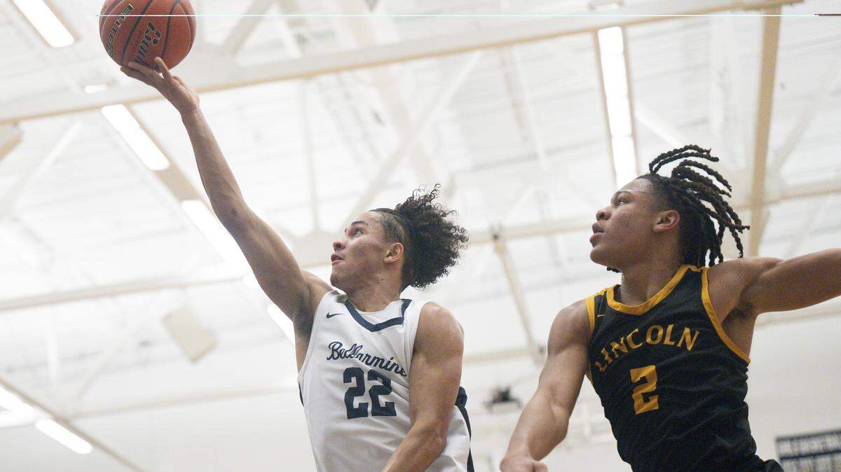 Bellarmine Lions junior Ronnie Wiggins (22) attempts a two-point shot with pressure from Lincoln Abes senior Kasey Williams (2) on Wednesday, Jan. 28, 2026, in Tacoma, Wash.
