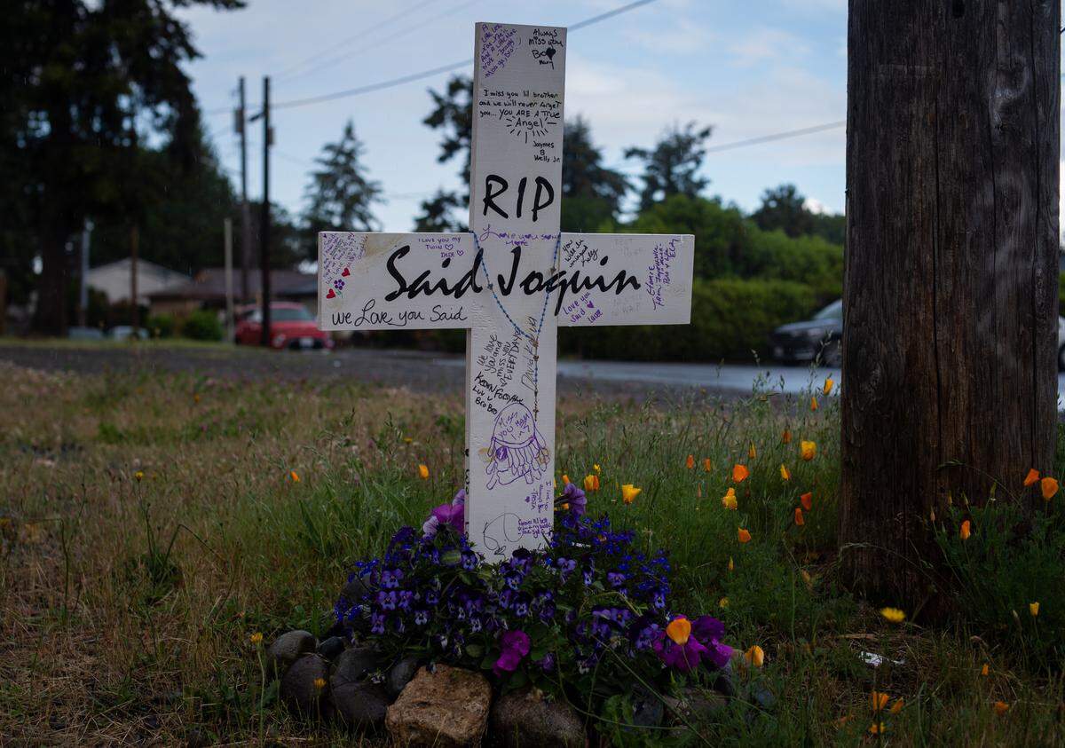 A cross marks the spot where Said Joquin was killed in an officer-involved shooting during a traffic stop on May 1. About 100 people marched through the streets as part of the Lakewood March of Solidarity in Lakewood, Wash., on Saturday, June 6, 2020.