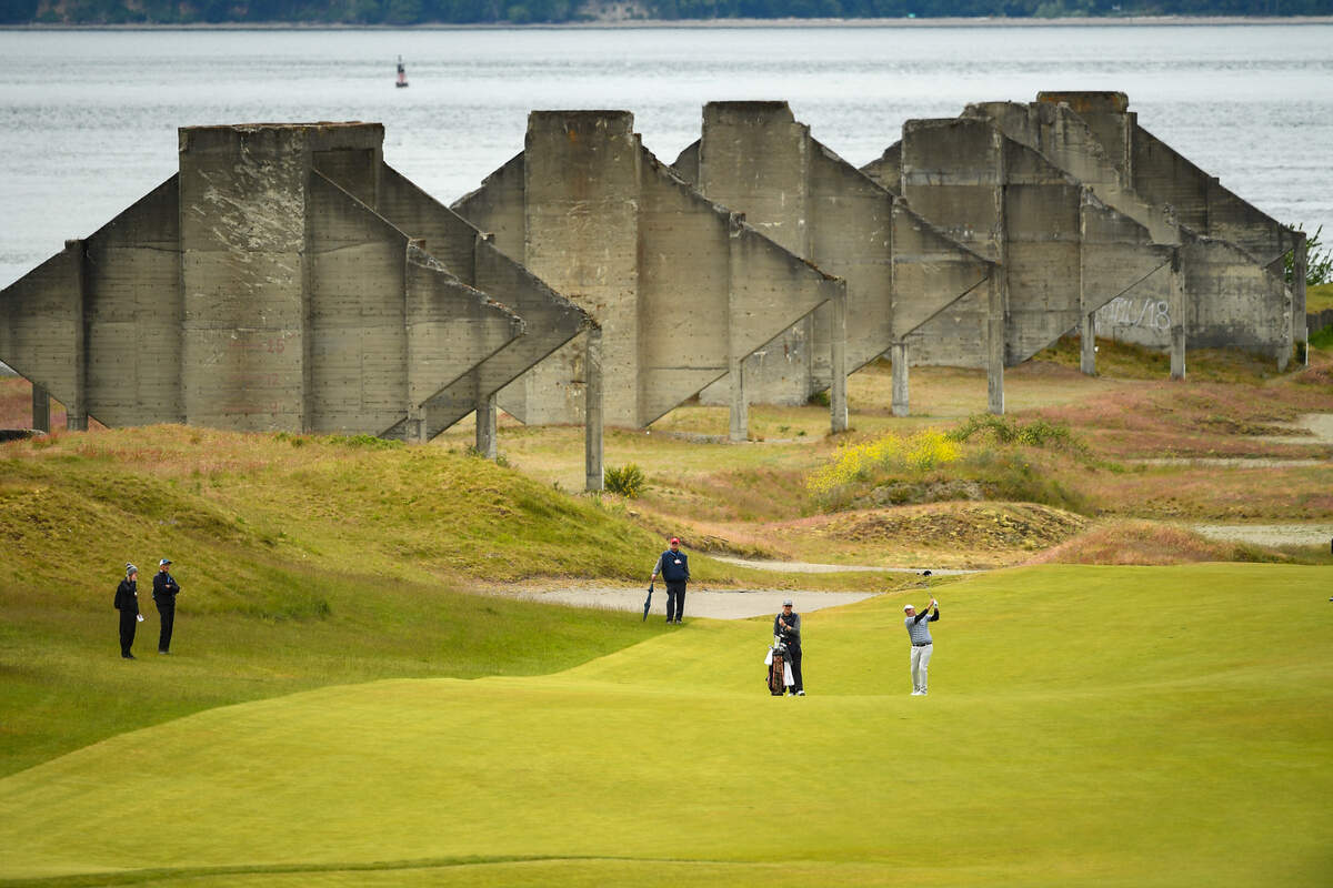 Chad Branton playing his approach shot to the 18th green during the round of 32 at the 2021 U.S. Amateur Four-Ball at Chambers Bay in University Place, Wash. on Monday, May 24, 2021. (Robert Beck/USGA)