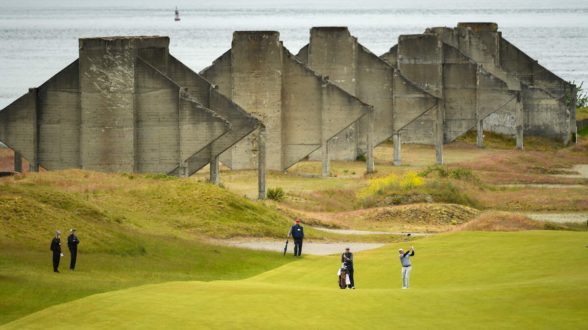 Chad Branton playing his approach shot to the 18th green during the round of 32 at the 2021 U.S. Amateur Four-Ball at Chambers Bay in University Place, Wash. on Monday, May 24, 2021. (Robert Beck/USGA)