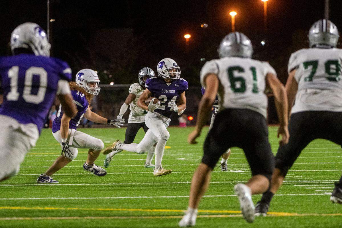 Sumner defensive back Jay Mentink runs back an interception thrown by Emerald Ridge quarterback Jake Schakel during the third quarter of a 4A SPSL game on Friday, Sept. 16, 2022, at Sunset Chev Stadium in Sumner, Wash.