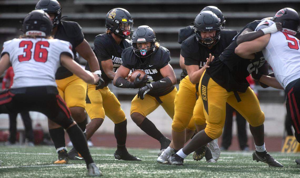 Lincoln running back Navarre Dixon looks for a hole in the Camas defense during Saturday afternoon’s 4A football game at Lincoln Bowl in Tacoma, Washington, on Sept. 17, 2022. Lincoln won the game, 42-28.