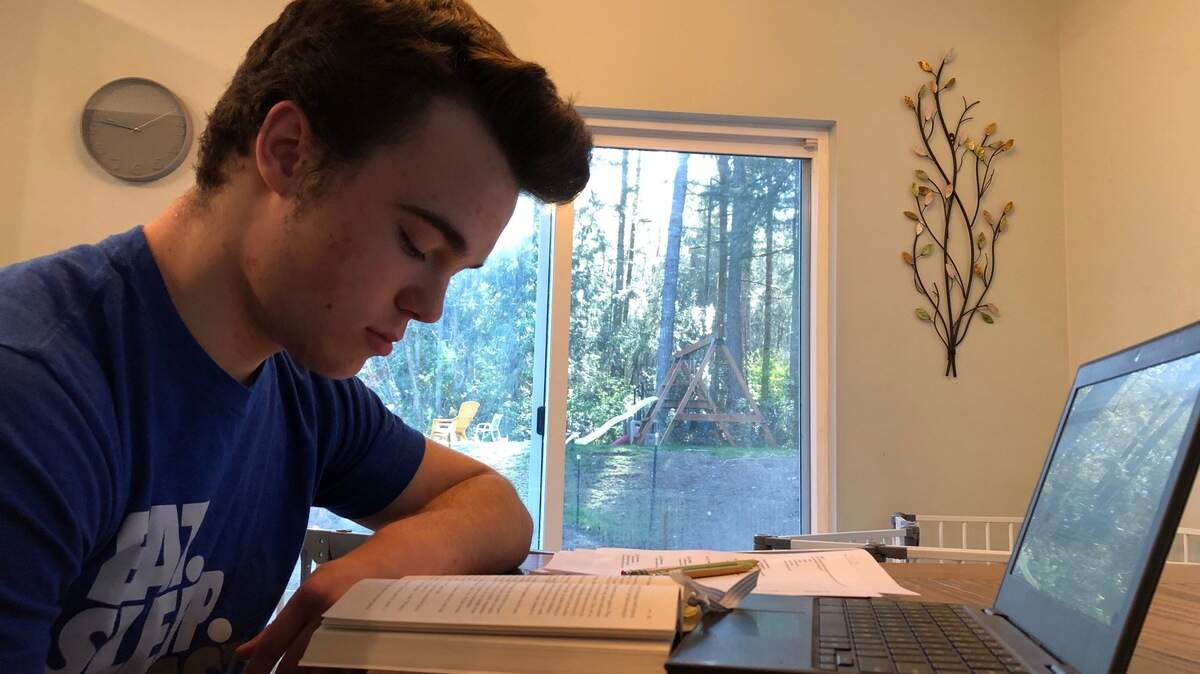 Brighton Wulbrecht, a freshman at Peninsula High School, hits the laptop at home.