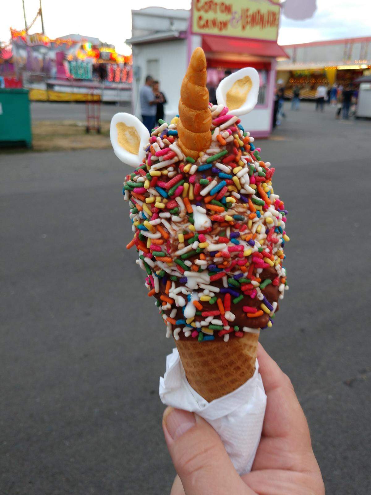 The Unicone is a vanilla soft serve ice cream cone dunked in chocolate, coated in sprinkles and decorated with a gold-dusted unicorn horn and ears.