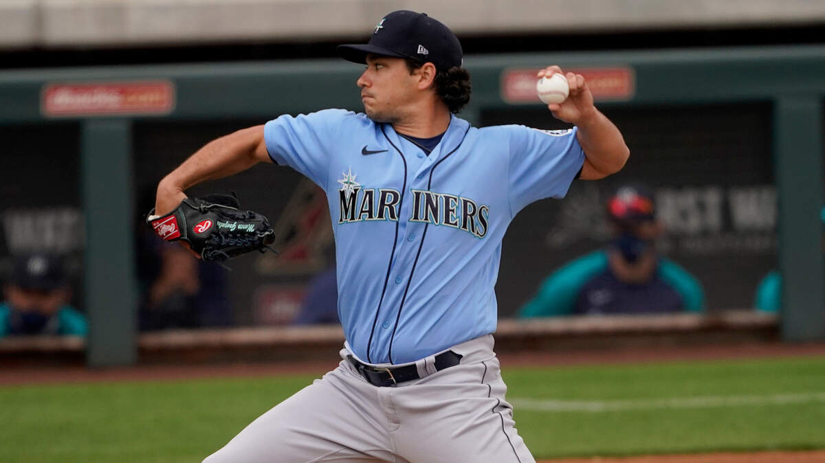 Seattle Mariners starting pitcher Marco Gonzales throws against the Colorado Rockies during the first inning of a spring training baseball game, Saturday, March 13, 2021, in Scottsdale, Ariz. (AP Photo/Matt York)