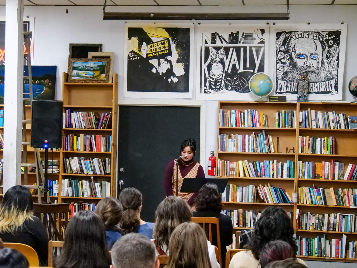 A University of Washington Tacoma student presents during Creative Colloquy’s “lit crawl” on Tuesday, Oct. 3 at a reading event held at King’s Books in Tacoma.