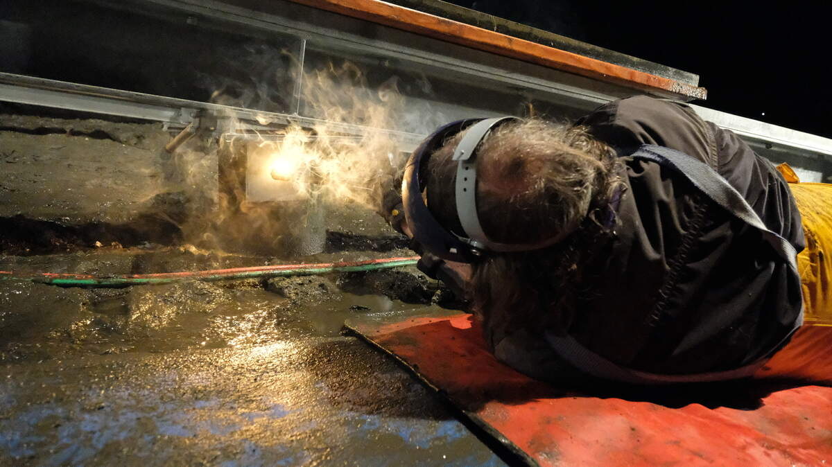 Volunteer Steve Paris uses a cutting torch recently to complete work at the Eddon Boatyard.
