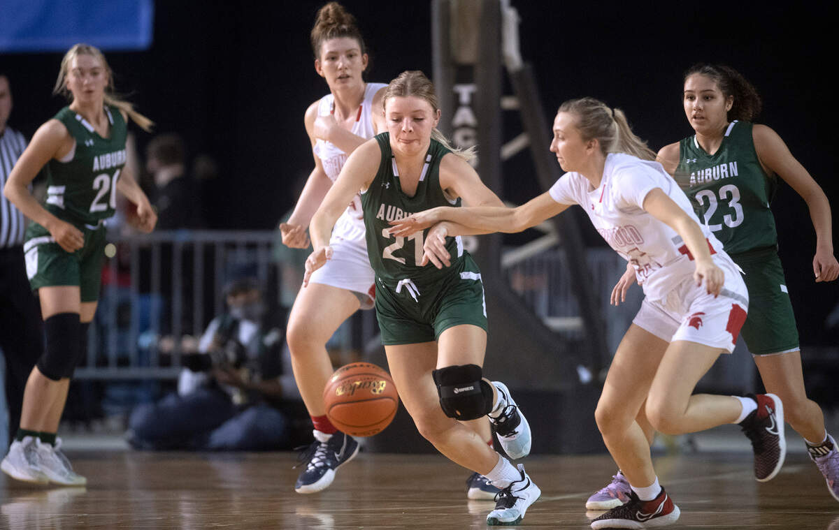 Auburn’s Rachel Crook steals the ball from Stanwood’s Cezanne DePew during Wednesday afternoon’s opening-round game of the WIAA 3A Girls Basketball State Championships tournament in the Tacoma Dome in Tacoma, Washington, on Wednesday, March 2, 2022.