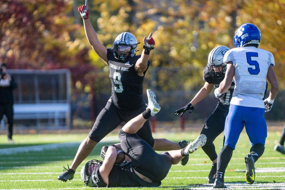 Emerald Ridge’s Bam Afalava (9) celebrates after Logan Lisherness intercepted a pass by Bothell quarterback Ryder Jacobsen during the first quarter of a Week 10 4A playoff game on Saturday, Nov. 5, 2022, at Sparks Stadium in Puyallup, Wash.