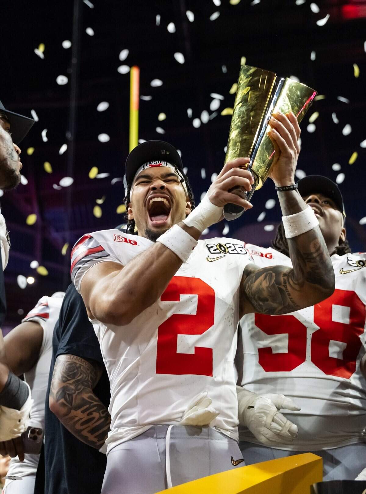 Jan 20, 2025; Atlanta, GA, USA; Ohio State Buckeyes wide receiver Emeka Egbuka (2) celebrates with the trophy after defeating the Notre Dame Fighting Irish during the CFP National Championship college football game at Mercedes-Benz Stadium. Mandatory Credit: Mark J. Rebilas-Imagn Images