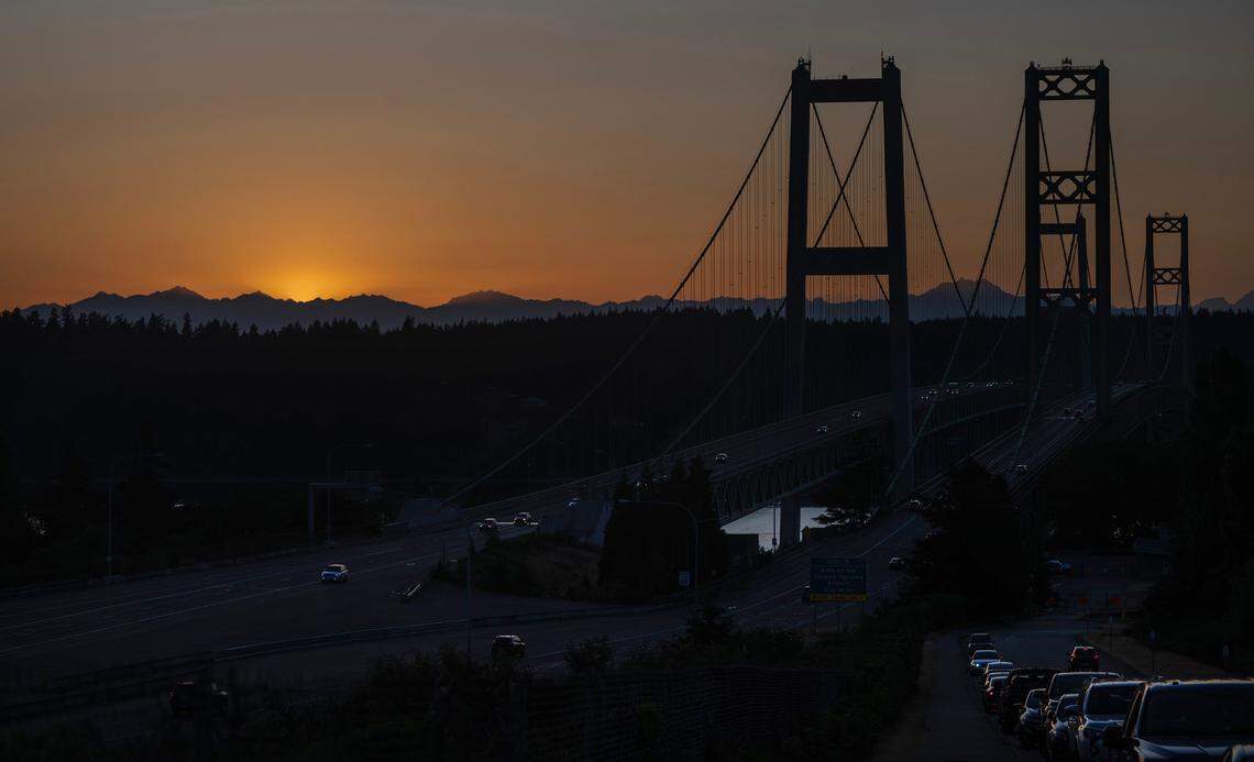 The view of Puget Sound, the Olympic Mountains and the Narrows bridges from 10th Street on the west slope of Tacoma, draws crowds in the evenings, shown on Saturday, July 13, 2024. Large events at The Sunset Estate at the top of the street create illegal parking and safety problems, say those living in the adjacent neighborhood.