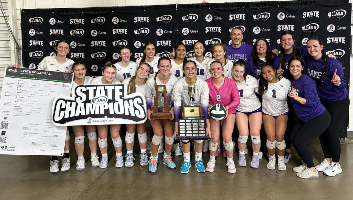 North Thurston High School’s volleyball team poses with the first-place trophy after their sweep of No. 2 Mount Spokane in the 3A state championship at the Yakima Valley SunDome on Nov. 22, 2025, in Yakima, Wash.