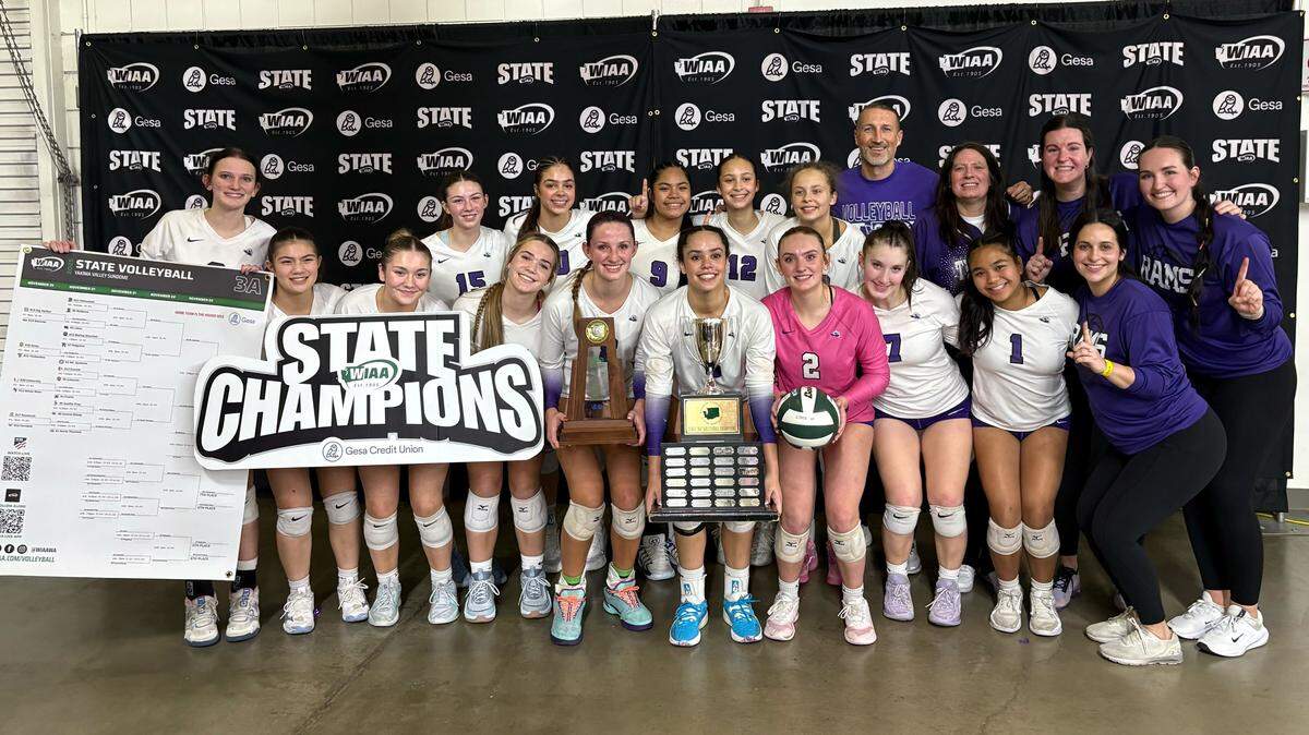 North Thurston High School’s volleyball team poses with the first-place trophy after their sweep of No. 2 Mount Spokane in the 3A state championship at the Yakima Valley SunDome on Nov. 22, 2025, in Yakima, Wash.