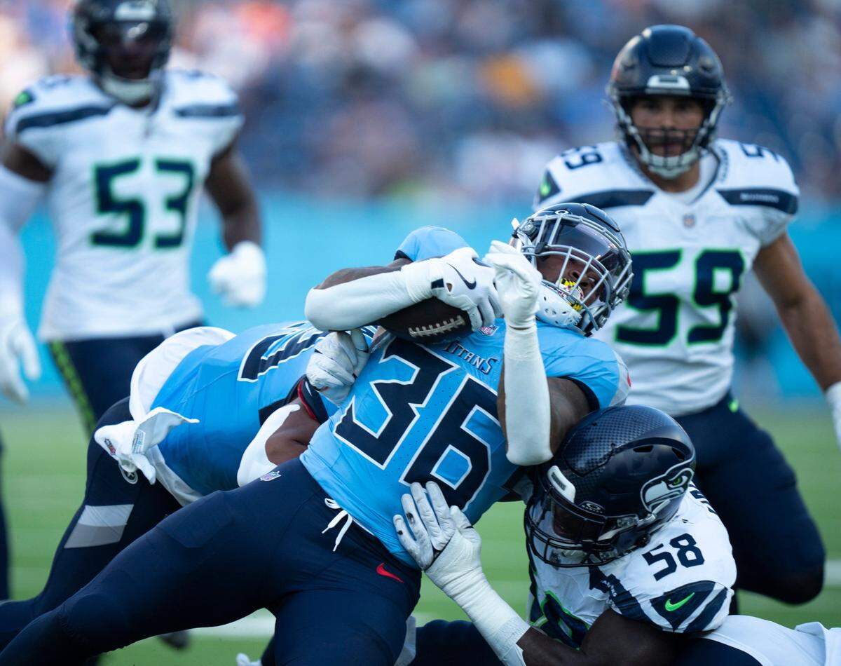 Tennessee Titans running back Julius Chestnut (36) runs against Seattle Seahawks linebacker Derick Hall (58) during their game at Nissan Stadium in Nashvillet, Tenn., Saturday, Aug. 17, 2024.