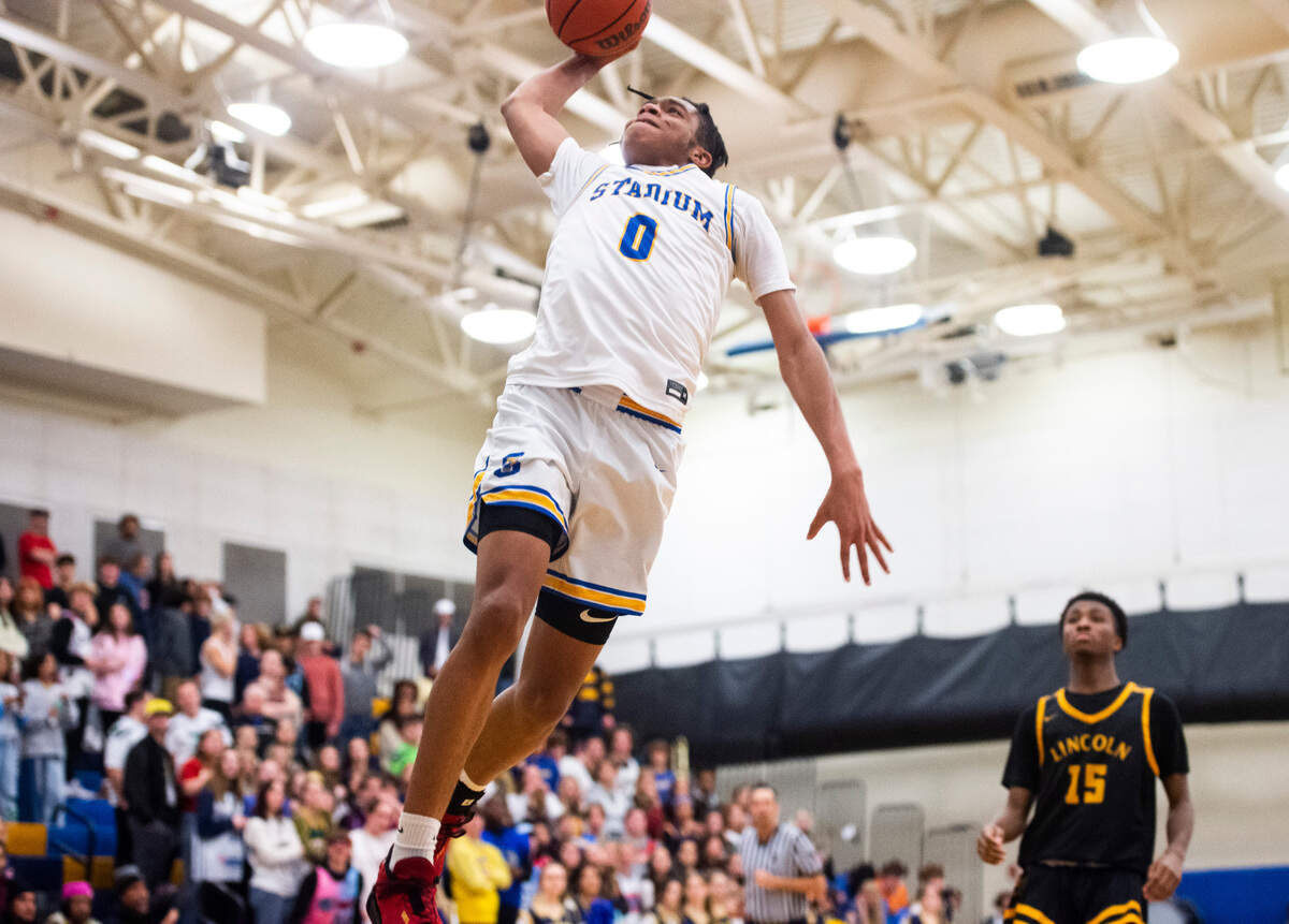 Stadium’s Ne’ Quan Brown (0) dunks the ball during a game against Lincoln at Stadium High School in Tacoma, Wash. on Jan. 18, 2023. Stadium defeated Lincoln 65-54.
