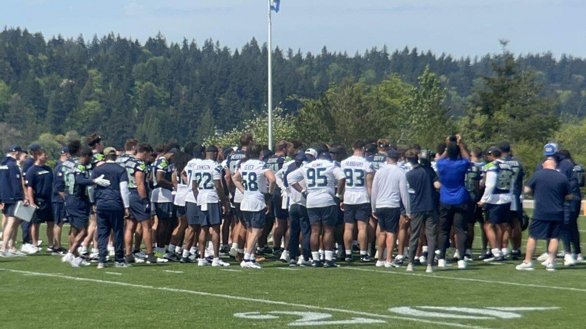 About 70 players -- drafted picks, signed undrafted free agents and (mostly) tryout guys -- gather around coach Mike Macdonald at the end of practice at Seattle Seahawks NFL rookie minicamp, Friday, May 1, 2026, at the Virginia Mason Athletic Center in Renton.