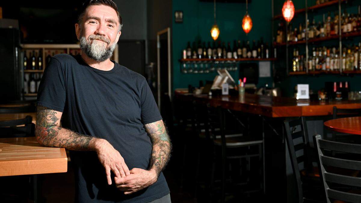 Owner Danny Puskarcik poses inside the The Blue Rose, Friday, July 28, 2023, in Tacoma. He bought Stink Meat and Cheese/El Tufo this summer and has rebranded it as The Blue Rose.