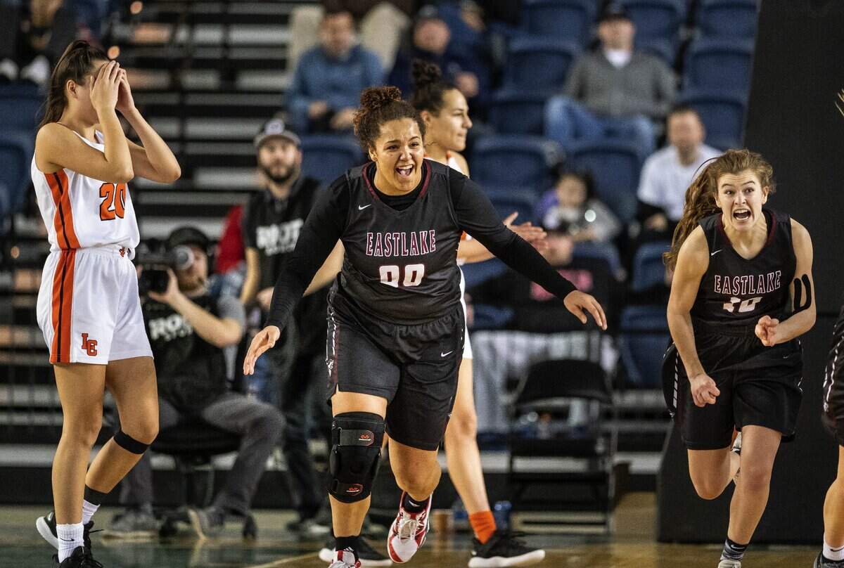 Keeli Burton-Oliver, center, and Calalie Lind, right, and the Eastlake girls celebrate their 4A Girls Championship over Lewis and Clark Saturday. Eastlake played Lewis and Clark in the Girls 4A State Basketball Championship Game Saturday, March 2, 2019 at the Tacoma Dome. 209429