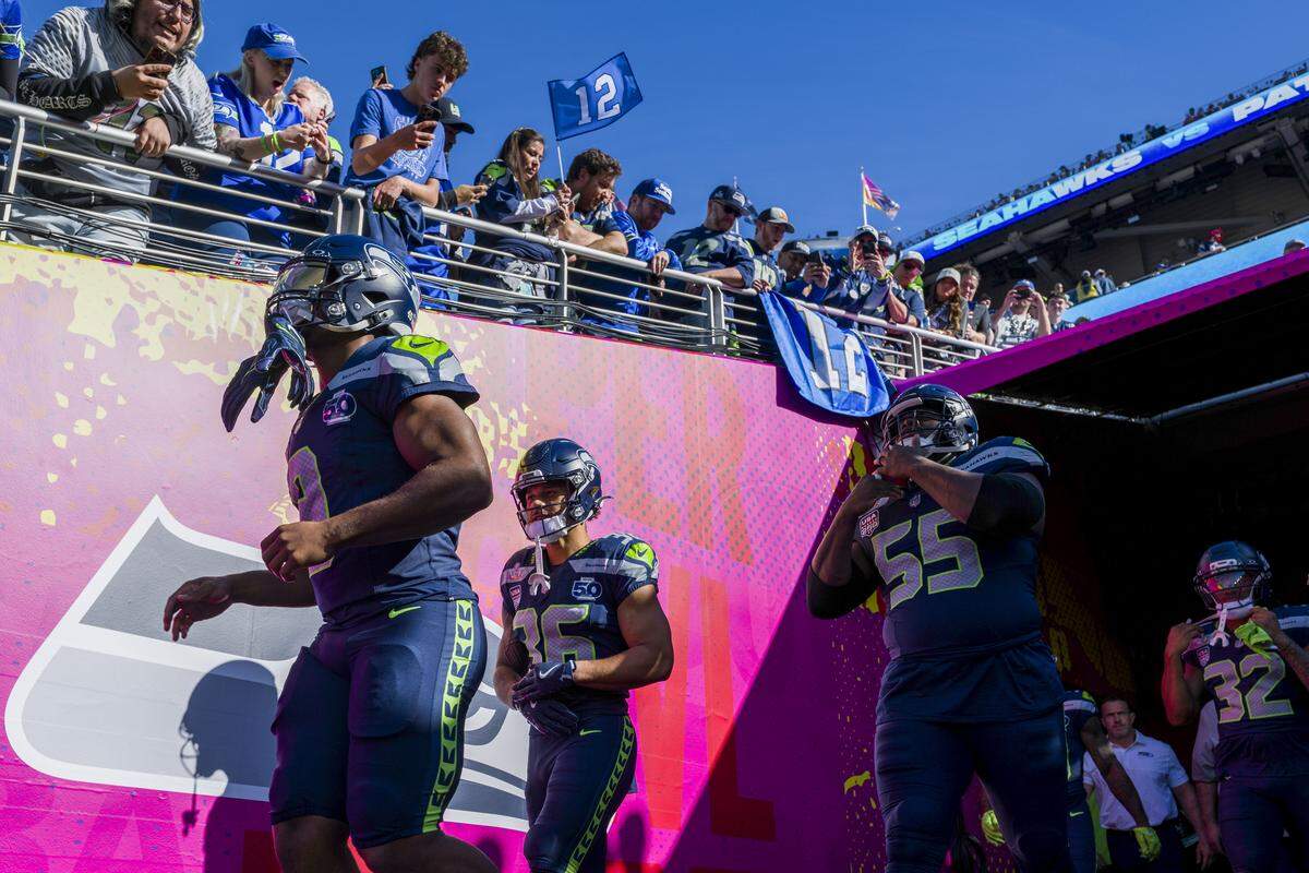 Seattle Seahawks running back Kenneth Walker III (left), running back George Holani (center), and center Olu Oluwatimi (right-center) walk through the tunnel on their way to warm ups prior to the start of Super Bowl LX at Levi's Stadium on Feb. 8, 2026 in Santa Clara, Calif.