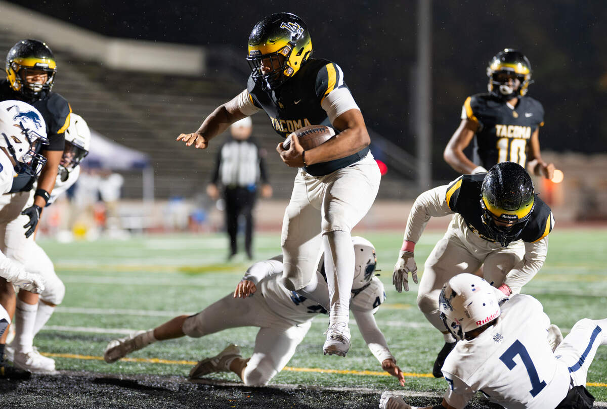 Lincoln’s Jadeon Scranton (8) leaps into the end zone for a touchdown during the first half of the game against Bellarmine Prep at Lincoln High School, on Friday, Oct. 18, 2024, in Tacoma, Wash.