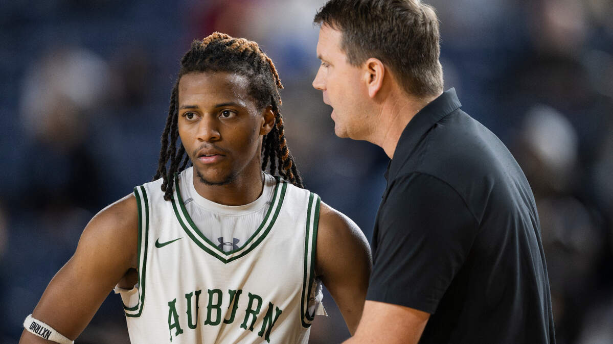 Auburn head coach Ryan Hansen talks to Elijah Jones (11) during the second half of a Class 4A state basketball tournament first-round game against Olympia at the Tacoma Dome on Wednesday, March 5, 2025, in Tacoma, Wash.
