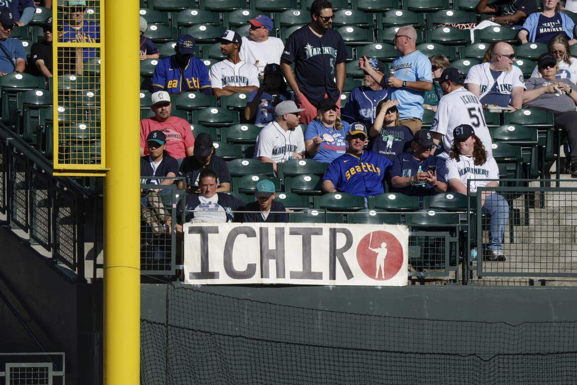 Aug 9, 2025; Seattle, Washington, USA; Fans sit in the right field stands behind a sign for Seattle Mariners former outfielder Ichiro Suzuki (not pictured) before a game against the Tampa Bay Rays at T-Mobile Park. Mandatory Credit: Joe Nicholson-Imagn Images