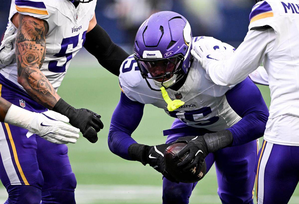 Minnesota Vikings linebacker Dallas Turner (15) picks off Seattle Seahawks quarterback Geno Smith (7) during the second quarter of the game at Lumen Field, on Sunday, Dec. 22, 2024, in Seattle, Wash.