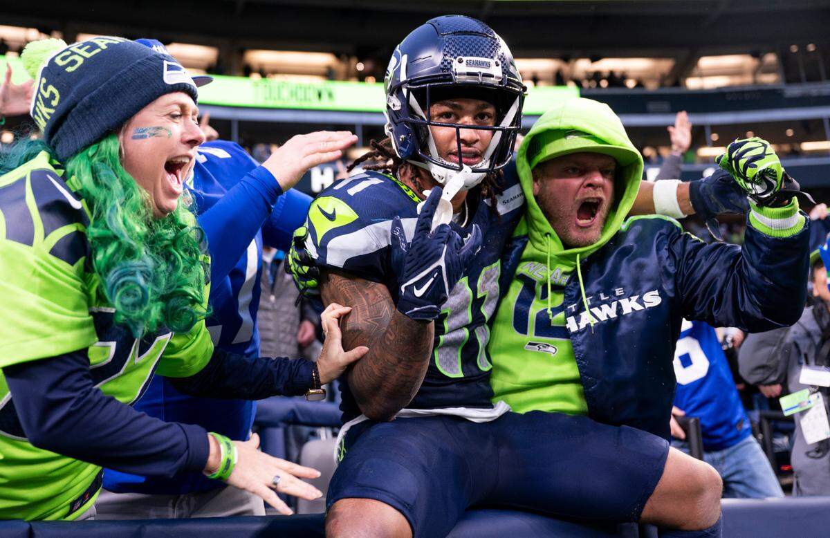 Seattle Seahawks wide receiver Jaxon Smith-Njigba (11) reacts to a touchdown with fans during the fourth quarter of the game against the Los Angeles Rams at Lumen Field, on Sunday, Nov. 3, 2024 in Seattle, Wash.