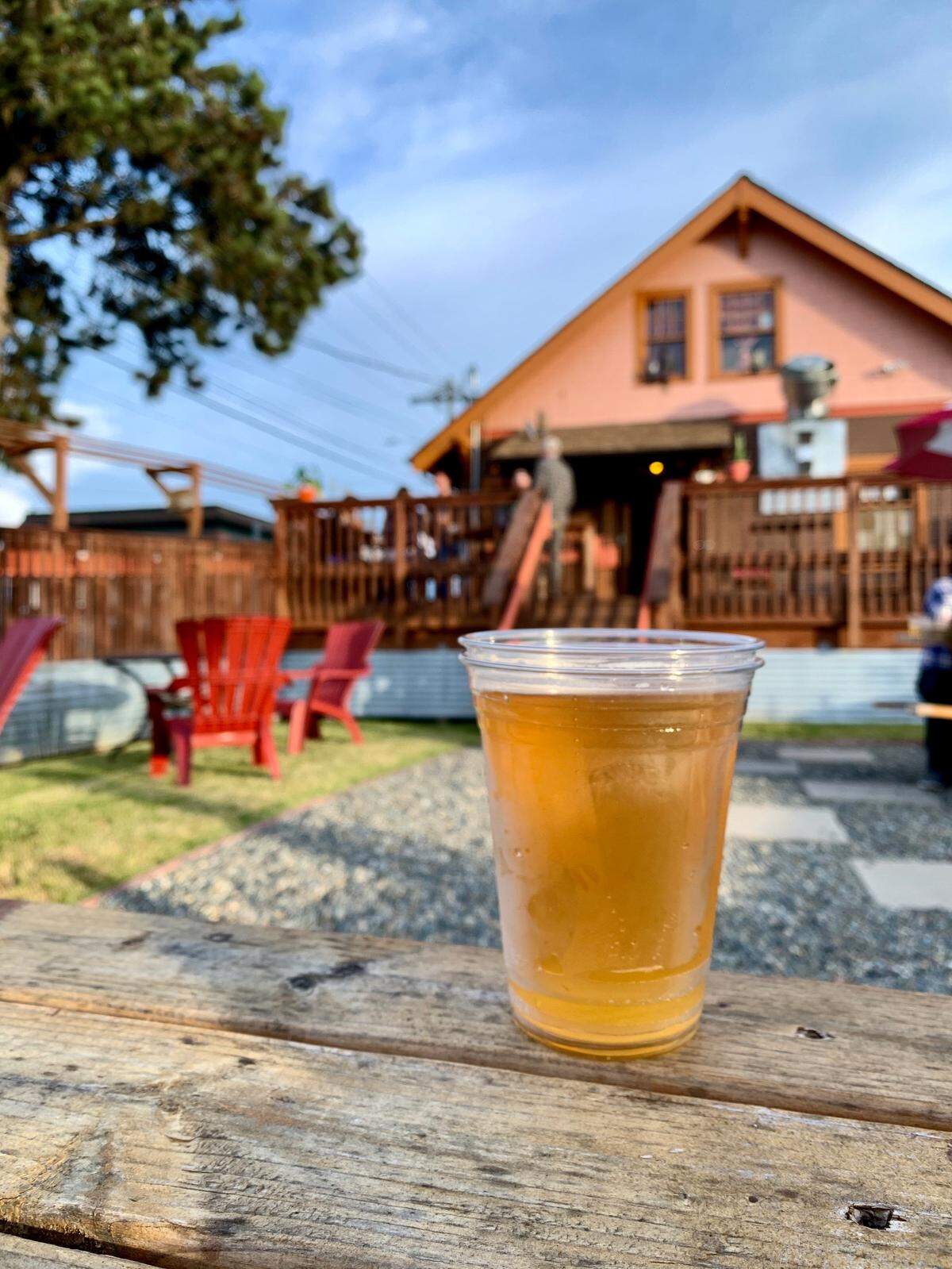 Dusty’s Hideaway boasts a large backyard deck and yard with picnic tables and adirondack chairs.