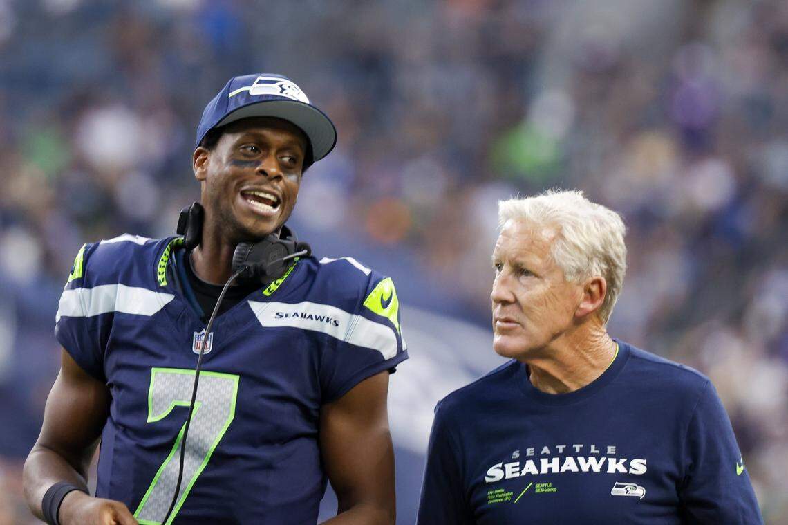 Aug 19, 2023; Seattle, Washington, USA; Seattle Seahawks quarterback Geno Smith (7) talks with head coach Pete Carroll during the second quarter against the Dallas Cowboys at Lumen Field. Mandatory Credit: Joe Nicholson-USA TODAY Sports