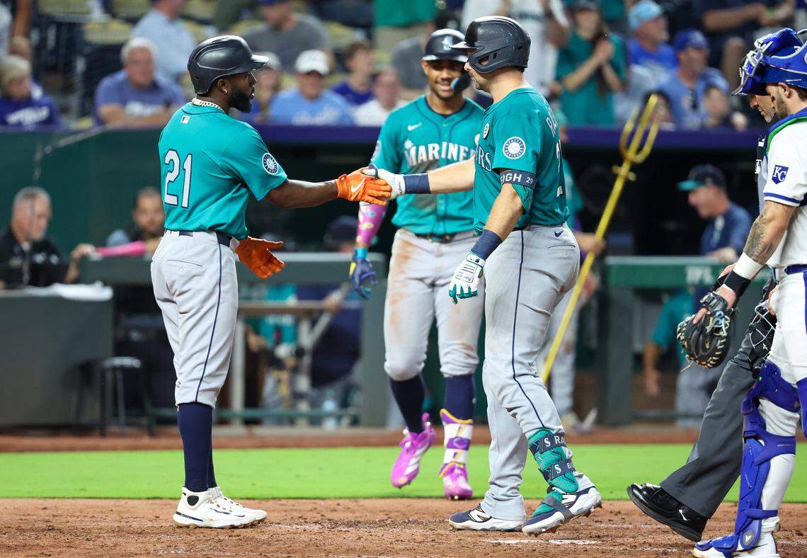 Sep 16, 2025; Kansas City, Missouri, USA; Seattle Mariners catcher Cal Raleigh (29) is congratulated by left fielder Randy Aronzarena (21) after hitting a home run in the top of the fourth inning against the Kansas City Royals at Kauffman Stadium. Mandatory Credit: Scott Sewell-Imagn Images