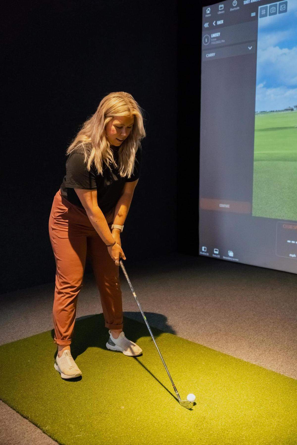 Lindsey Gullikson leads the golf program at Stadium Golf, a new interactive sports bar in Tacoma outfitted with six TrackMan golf simulators.