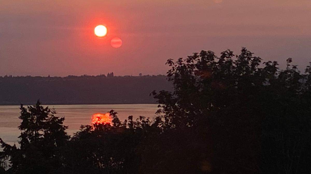 The sun rises over Commencement Bay in Tacoma, Washington, through a haze of wildfire smoke Friday, Sept. 9, 2022. Smoky haze has held on into October, but rain is in the forecast.