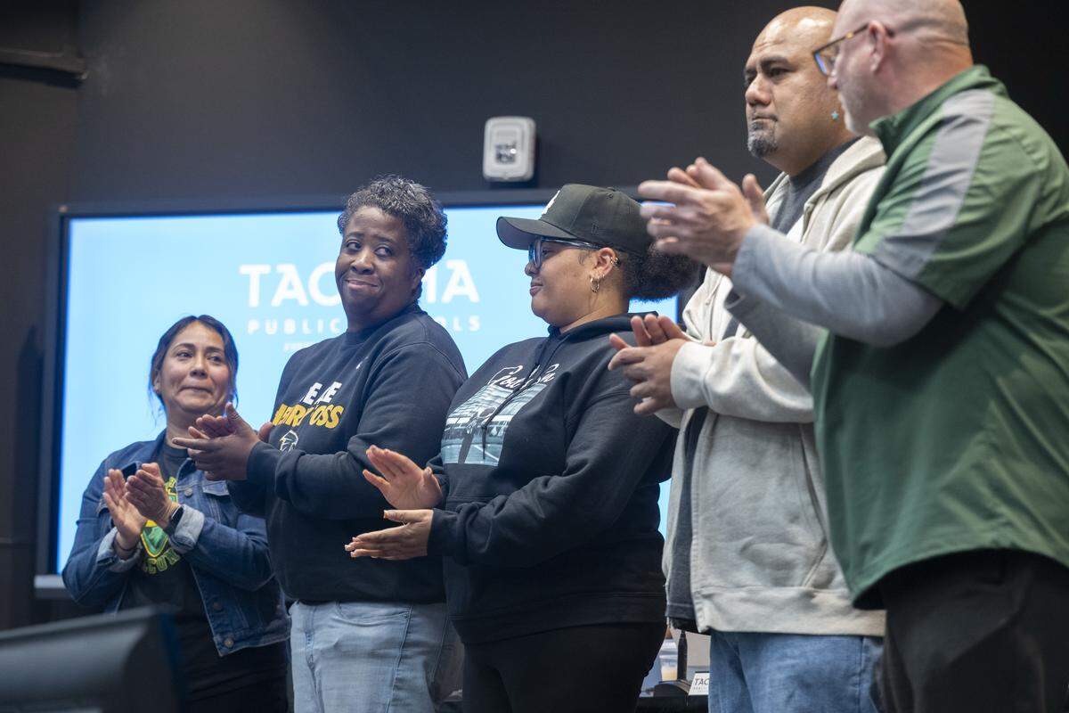 Foss High School staff, from left, nurse Ada Gutierrez, athletic director Shiante Reed, campus security guards Sharrese LuRee Johnson and Bonhoeffer (Bon) Muao, and coach David (Coach Mac) McEachern, are recognized for intervening during an aggravated assault at Foss in April. Four received a Medal of Courage, while Gutierrez received a Certificate of Merit at the Tacoma Public Schools Professional Development Center in Tacoma, Wash.