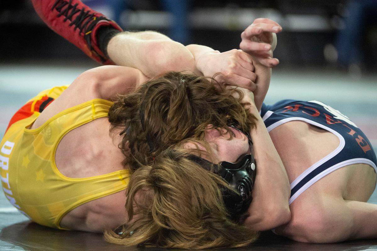 Orting’s Quentin Harding cradles Black Hills’ Mikey Johnston during their 113-pound 2A championship match at Mat Classic XXXIII on Saturday, Feb. 19, 2022, at the Tacoma Dome in Tacoma, Wash.