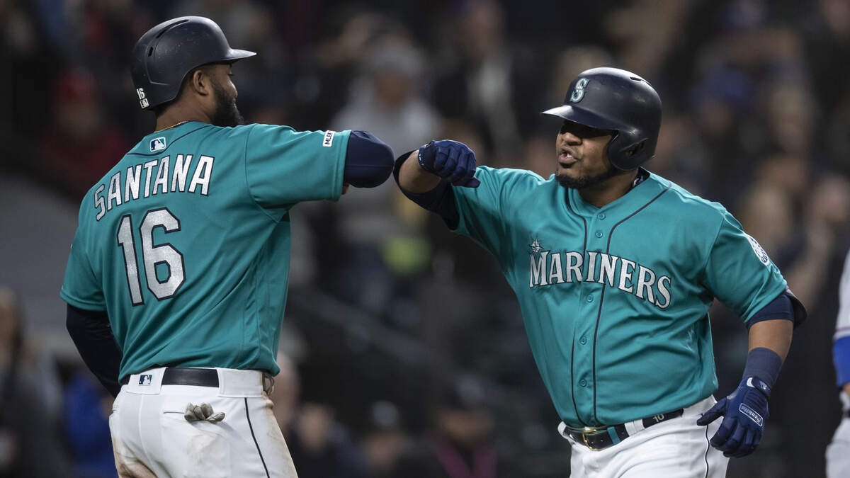 Seattle Mariners’ Edwin Encarnacion, right, is congratulated by Domingo Santana after hitting a three-run home run off of Texas Rangers starting pitcher Shelby Miller that also scored Santana and Daniel Vogelbach during the third inning of a baseball game, Friday, April 26, 2019, in Seattle. (AP Photo/Stephen Brashear)