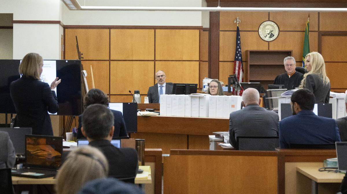 Prosecuting attorney Lori Nicolavo, left, asks Pierce County Superior Court Judge Bryan Chushcoff  if defense attorney Anne Bremner, right, should be allowed to demonstrate how a suspect is restrained in the trial of three Tacoma Police officers regarding the killing of Manny Ellis at Pierce County Superior Court, Wednesday, Nov. 29 2023, in Tacoma, Wash. On the witness stand is Chris Nielsen, right, a use-of-force expert.  The judge allowed the demonstration to occur.   Tacoma Police Officers Christopher Burbank, Matthew Collins and Timothy Rankine stand trial for charges related to the March 2020 killing of Manny Ellis. (Ellen M. Banner / Pool / The Seattle Times)