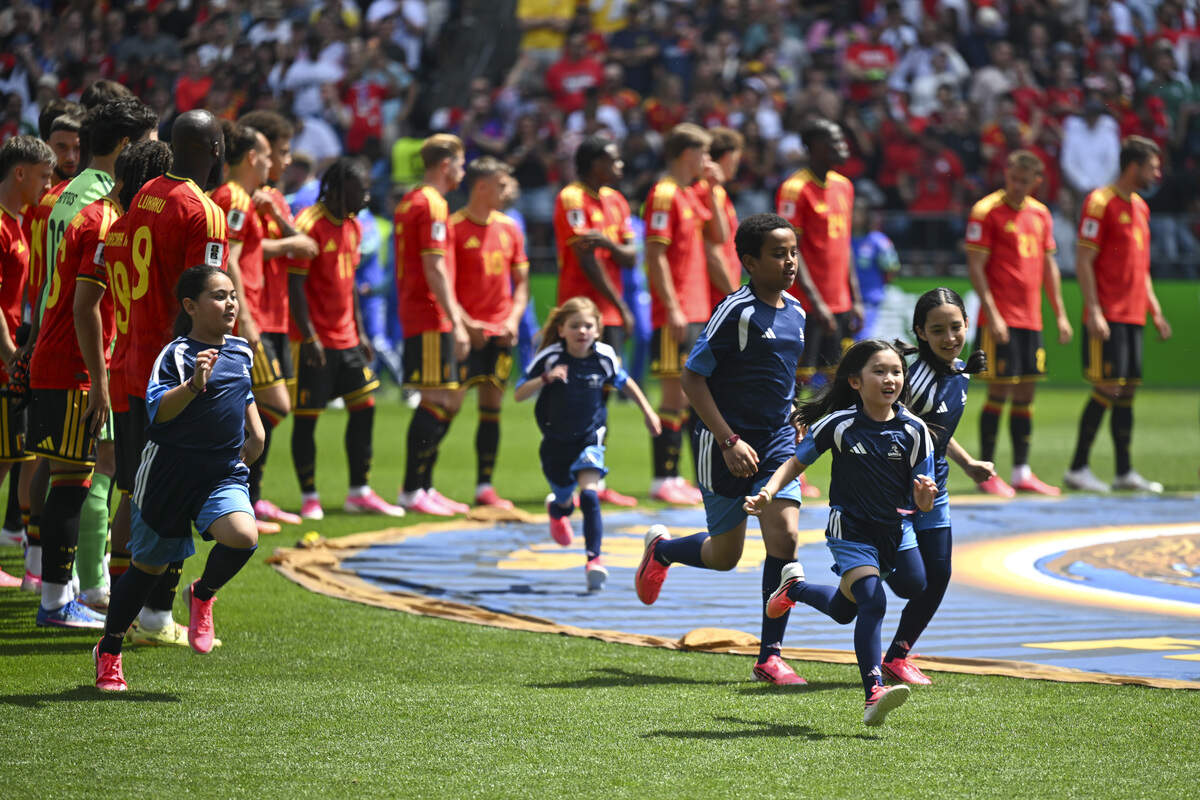 Player escorts run off the field after opening ceremonies for the FIFA World Cup game between Belgium and Egypt on Monday, June 15, 2026, in Seattle, Wash.