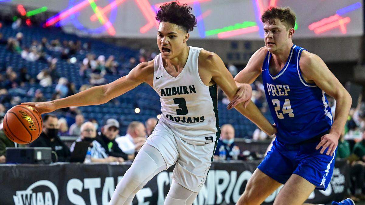 Auburn guard Maleek Arington (3) drives to the basket as Seattle Prep forward Neven Marinkovic (24) defends during the first quarter of a Class 3A semifinal state tournament game on Friday, March 4, 2022, at the Tacoma Dome, in Tacoma, Wash.